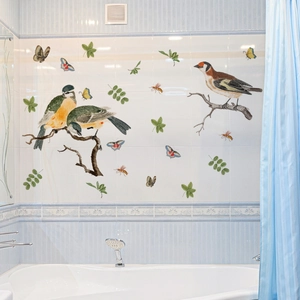 Detail view of colorful bird and butterfly wall stickers on white bathroom tiles