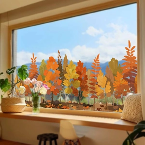 Detail of autumn forest window clings featuring hand-painted orange trees and colorful leaves