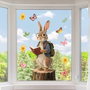 Detail of cartoon rabbit window sticker with butterflies and flowers on glass pane