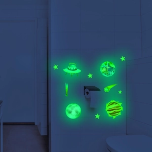Luminous space theme wall stickers featuring glowing planets and UFO in dark bathroom