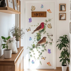 Close-up of realistic bird and butterfly wall stickers on a minimalist white door