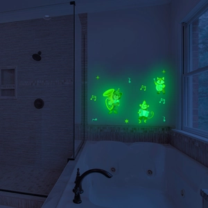 Luminous wall stickers set showing cartoon animals glowing in a dark bathroom setting