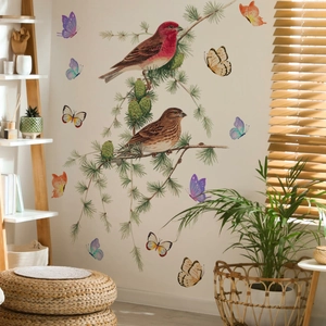 Detail of DIY wall stickers featuring realistic birds, butterflies and pine branches