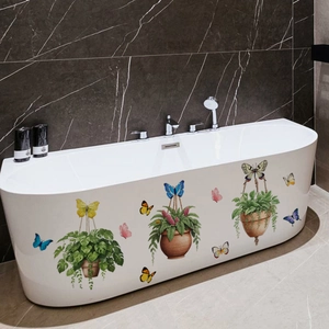 Detail of waterproof butterfly and potted plant wall decals applied on a white bathtub