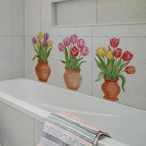 Detailed view of three colorful tulip flower wall stickers applied on bathroom tiles