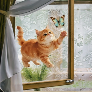 Detailed view of orange cat and butterfly static window cling on glass window frame