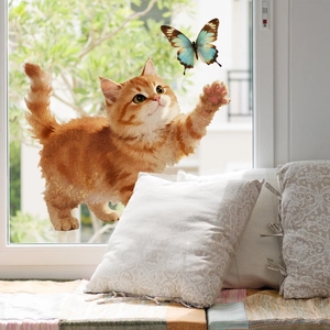 Detail of static window cling featuring a tabby cat chasing a butterfly on glass