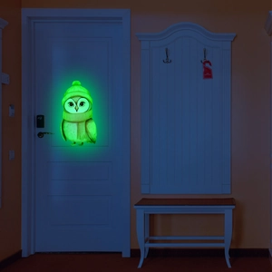 Glow-in-the-dark cartoon owl wall sticker emitting bright green light in night home scene