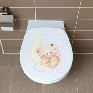 Glow-in-the-dark toilet sticker showing a cute bear sleeping on a yellow crescent moon