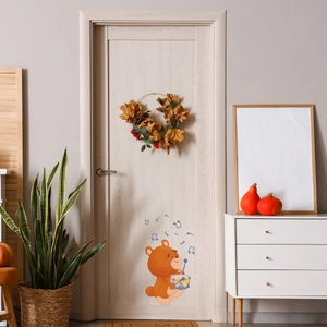 Detailed view of luminous cartoon bear door sticker in a cozy home interior setting
