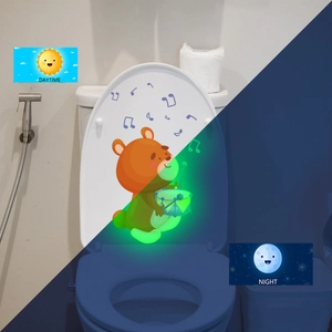 Glow-in-the-dark bear toilet sticker showing contrast between daytime and luminous night effect