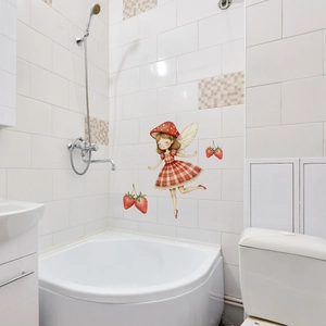 Detailed view of luminous mushroom fairy wall sticker applied to clean white bathroom tiles
