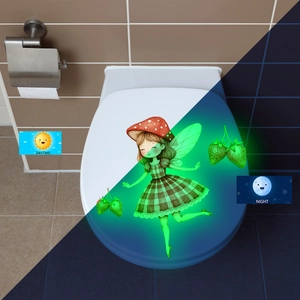 Glow-in-the-dark toilet sticker showing daytime view and night-time green fairy luminous effect