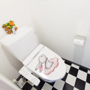 Detailed view of a watercolor rabbit on pink cloud sticker applied to a toilet lid