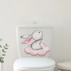 Close-up of cute watercolor rabbit and pink cloud sticker on a white toilet tank