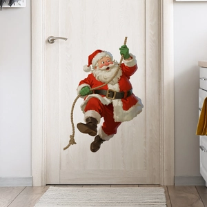 Detail of Santa Claus climbing rope wall sticker on a white door for Christmas decoration