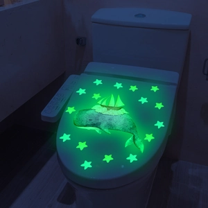 Luminous wall stickers set featuring a glowing whale, sailboat and stars for home decor