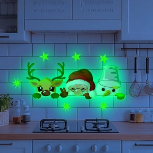 Luminous Christmas decals featuring Santa and reindeer glowing in dark home settings
