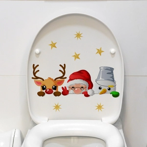Detail of luminous Christmas stickers with Santa and reindeer on a white toilet lid