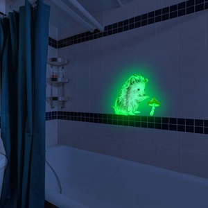 Luminous wall sticker showing a cute hedgehog with mushrooms glowing green in a dark bathroom