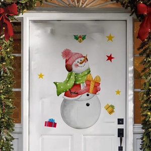 Detailed view of festive Christmas snowman door stickers on a white wooden background