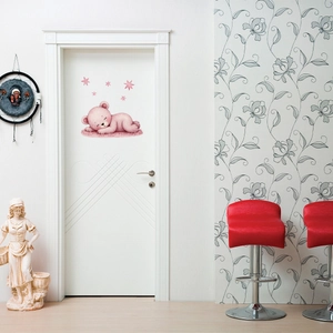 Glow-in-the-dark wall sticker featuring a cute pink sleeping bear and stars on a door