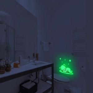 Glow-in-the-dark wall sticker featuring a sleeping bear and stars in green fluorescence