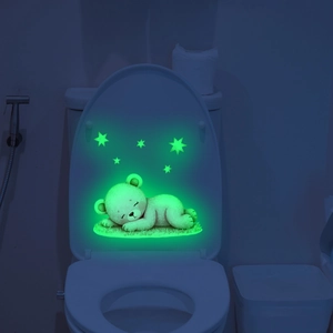Luminous toilet lid sticker showing a sleeping cartoon bear and glowing stars in the dark