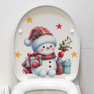 Close-up of a festive snowman toilet lid decal featuring a red scarf and holly decorations