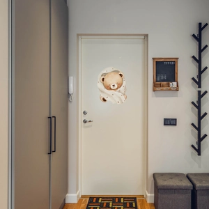 Detailed view of cozy sleeping bear wall sticker on a minimalist white wooden bedroom door