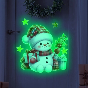 Close-up of luminous Christmas snowman sticker glowing green on a dark wood door