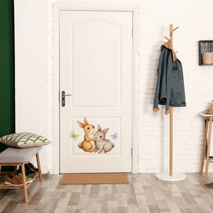 Charming cartoon rabbits and butterflies luminous wall stickers on a white wooden door