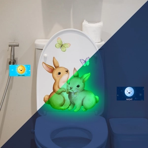 Luminous toilet lid stickers with cartoon rabbits and butterflies in day and night views