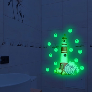 Luminous lighthouse wall decal showing green glow-in-the-dark effect on bathroom tile