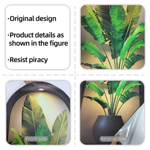 Detail showing tropical green leaf wall sticker with adhesive backing being peeled off