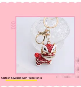 Detailed view of rhinestone-encrusted Chinese dancing lion keychain with red enamel finish