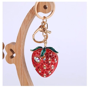 Detail of strawberry rhinestone keychain with red crystals and gold lobster clasp