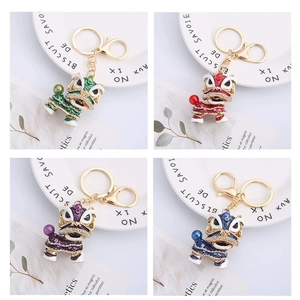 Detail of colorful enamel lion dance keychains with rhinestones in a four-grid display
