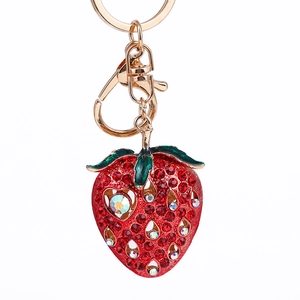 Sparkling strawberry keychain with red rhinestones and green enamel on gold metal base