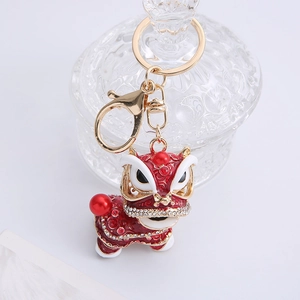 Detail of red Chinese lion dance keychain with rhinestones and gold plating