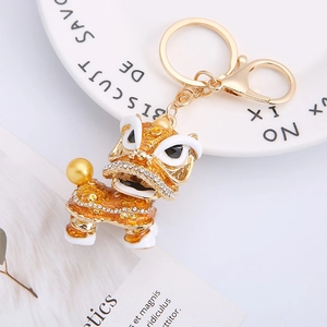 Traditional Chinese lion dance keychain with orange enamel and sparkling crystals