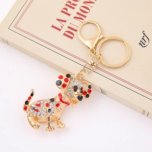 Detailed view of luxury dalmatian dog keychain with white crystals and gold finish