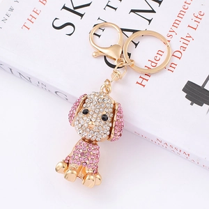Detailed view of dog keychain featuring sparkling pink rhinestones on gold-toned metal