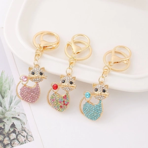 Three creative cat keychains with colorful rhinestones on a gold alloy metal base
