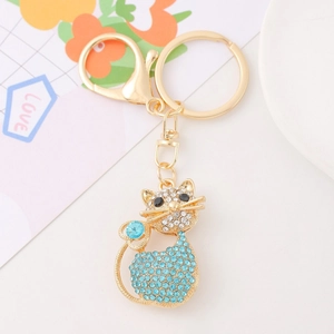 Close-up of cat keychain with blue and white rhinestones and a golden lobster clasp