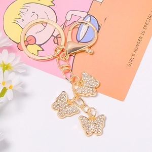 Elegant gold butterfly keychain with sparkling rhinestones and a lobster clasp charm