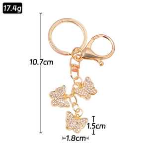 Golden butterfly keychain with three rhinestone pendants and lobster clasp, 10.7cm length