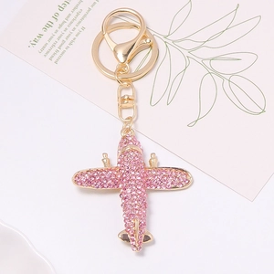 Pink rhinestone airplane keychain with gold-tone metal base and lobster clasp