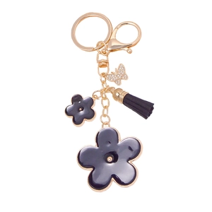 Golden butterfly and black flower enamel keychain with leather tassel and rhinestones