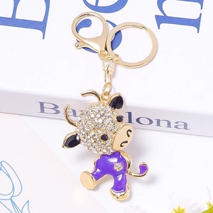 Detail of purple enamel ox keychain with crystal rhinestones and golden lobster clasp